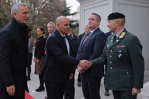 Macedonian official and NATO official handshake