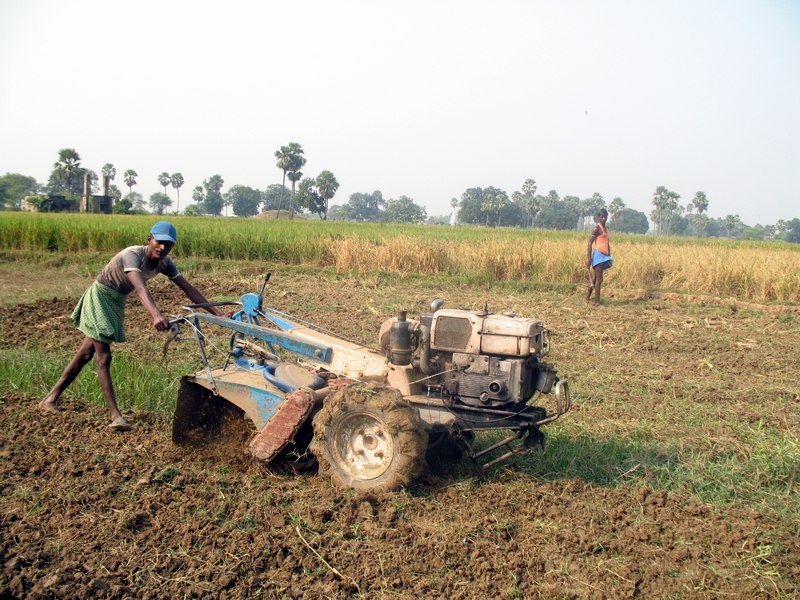 Farm workers in Bihar in the fields with machinery