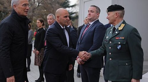 Macedonian official and NATO official handshake