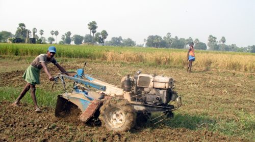 Farm workers in Bihar in the fields with machinery